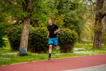 Male athlete in sprint run wearing sports running shoes and shorts in workout for marathon