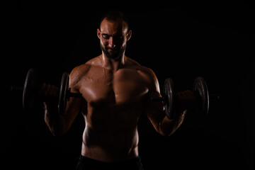 Fototapeta na wymiar Portrait of topless guy lifting weights