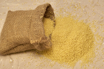 croup couscous poured out of a canvas bag on the table