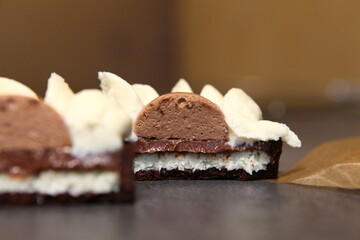 Tart slice with meringue on a dark background. Side view. Professional dessert. Coconut filling, coco inside the tart. 