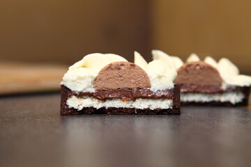 Tart slice with meringue on a dark background. Side view. Professional dessert. Coconut filling, coco inside the tart.
