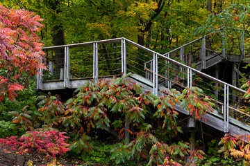 Wooden public zigzag staircase on the Cap-Rouge cliff seen during a during a cloudy fall day,...