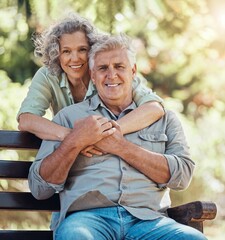 Love, portrait and elderly couple hug and bonding in a park, happy and relax in nature together....