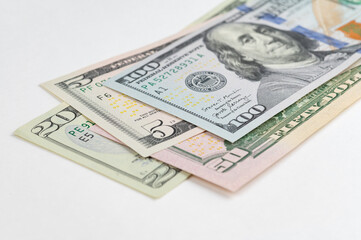5, 20, 50, 100 dollars banknotes at different angles. Close up of dollars on white background.