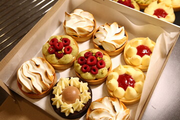 Tart with raspberry and cream. Pie with meringue. Set of desserts. Set of tarts. Different filling, and topping inside dessert.