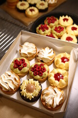 Tart with raspberry and cream. Pie with meringue. Set of desserts. Set of tarts. Different filling, and topping inside dessert.