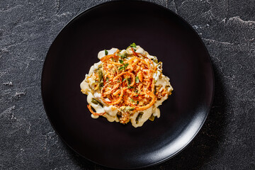 cheesy green bean casserole on plate, top view