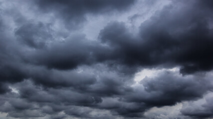 The dark sky with heavy clouds converging and a violent storm before the rain.Bad or moody weather...