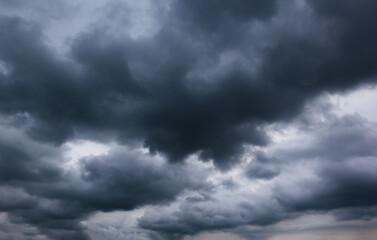 The dark sky with heavy clouds converging and a violent storm before the rain.Bad or moody weather...