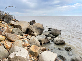Rocky section of the shore of Lake Khanka in autumn. Russia, Primorsky Krai