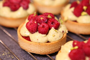 Tarts with raspberry and cream. Pie with meringue. Set of desserts. Set of tarts. Closeup view, macro.