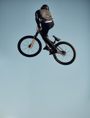 Cycling, bicycle and man doing a sky jump trick for a sports freestyle competition, game or travel...