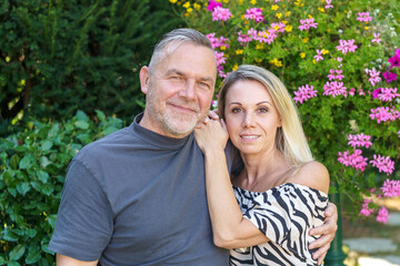 Fototapeta premium Happy middle aged couple posing arm in arm