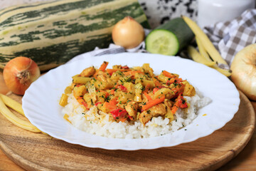 Chicken with vegetables and rice.