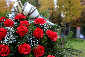 Funeral wreath with red roses. Flower decoration for the grave