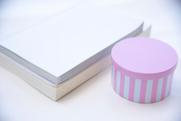 Pink gift box with white book.