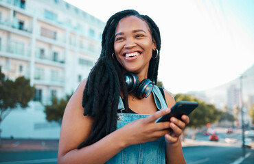 Student, street and happy girl with smartphone enjoying leisure break on weekend in Los Angeles. Black woman hipster with smile on commute with phone and headphones for music streaming in city.