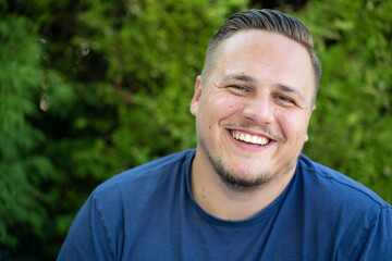 Young man enjoying a good joke laughing happily