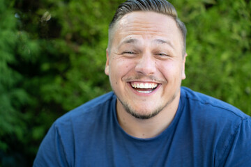 Young man enjoying a good joke laughing happily