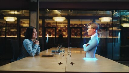 Video call chat conference of an asian woman using hologram technology. Conversing with a cartoon character avatar of young man. Advanced technology. VFX. Augmented reality. - Powered by Adobe
