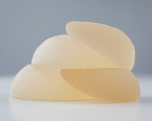 A pile of breast implants on a white background.