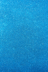Background with sparkles. Backdrop with glitter. Shiny textured surface. Vertical image. Strong blue