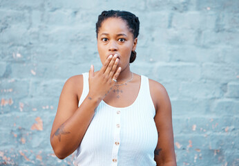Shocked black woman, hand and worry in silence for secret against a wall background. Portrait of...