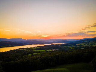 Naklejka na ściany i meble Aerial view of sunset over Windermere in Lake District, a region and national park in Cumbria in northwest England