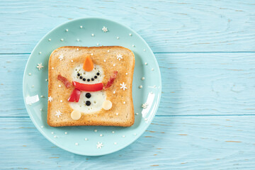 Christmas breakfast: toast with egg white in the shape of happy snowman