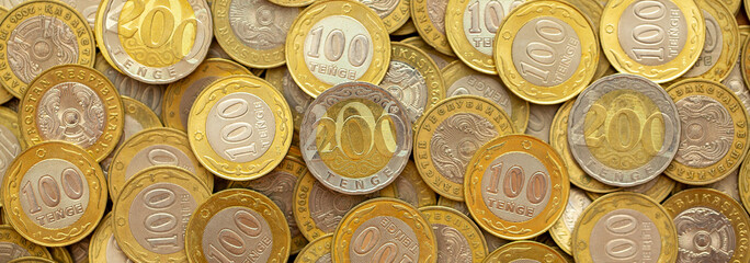 Coins of the state of Kazakhstan close-up. Kazakhstani coins of 200 and 100 tenge on a banknote. The concept of banking and inflation. - obrazy, fototapety, plakaty