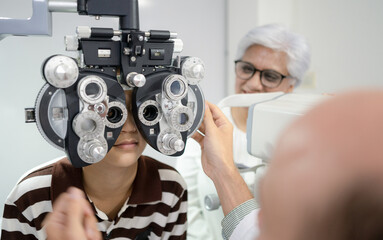 Boy has his eyes checked for glasses by a specialist.