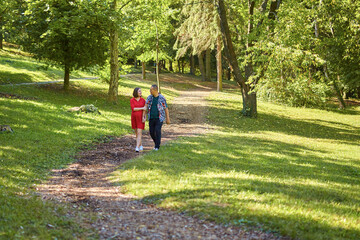 Lovely pregnant couple walking in a park