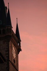 Beautiful sunrise over Prague landmarks, view to Old Town Tower clock and Tyn Cathedral. Travel to Czech Republic.