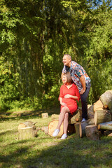 Lovely pregnant couple walking in a park
