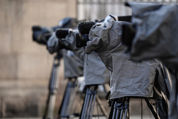 Television live broadcasting production professional cameras on tripod with rain covers on them...