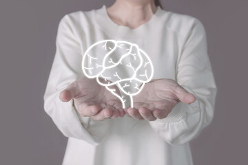 Woman hand holds illustrator of brain. Mental health protection and care.