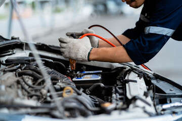 Close-up of automotive service technicians, repairs, maintenance and people concepts. Auto mechanic in the garage. Repair service concept.