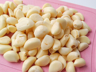 Group Fresh whole peeled garlic cloves background
