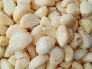Fresh whole peeled garlic cloves background