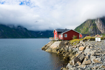 Traditional red wooden house on the coast of Reinefjorden, Lofoten, Norway