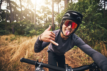 Mountain bike, cycling and fitness with a man gesture a shaka hand sign while training or exercise...