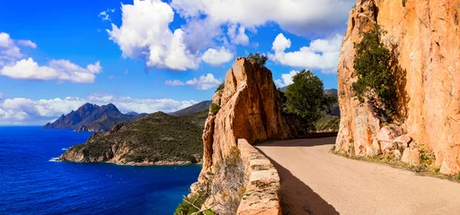 Poster amazing Corsica island nature landscape. Scenic road near Porto Ota with famous red rocks, western part © Freesurf