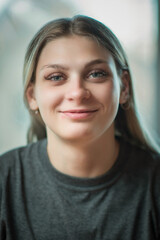 Close-up portrait of a young beautiful fair-haired girl with an interesting expression on her face.