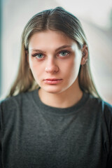 Close-up portrait of a young beautiful fair-haired girl with an interesting expression on her face.