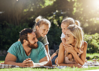 Picnic park and family with children relax on grass together for outdoor bonding, love and care...