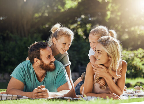 Picnic Park And Family With Children Relax On Grass Together For Outdoor Bonding, Love And Care With Sunshine Summer Lens Flare And Trees. Nature, Healthy And Support Parents With Girl Kids On Ground