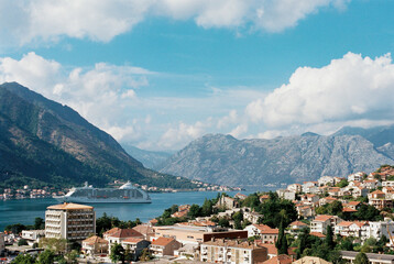 Fototapeta na wymiar White cruise ship sails along the Bay of Kotor. Montenegro