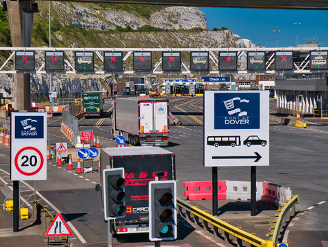 Lorries arriving at the busy Port of Dover in Kent, UK. Signage and traffic lanes are visible.