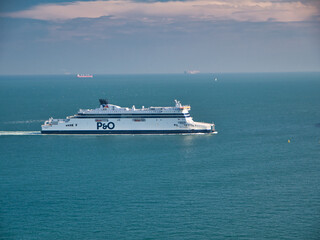 A white P&O cross channel ferry approaches the Port of Dover. Taken on a calm day with flat seas in summer.