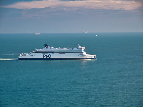 A white P&O cross channel ferry approaches the Port of Dover. Taken on a calm day with flat seas in summer.